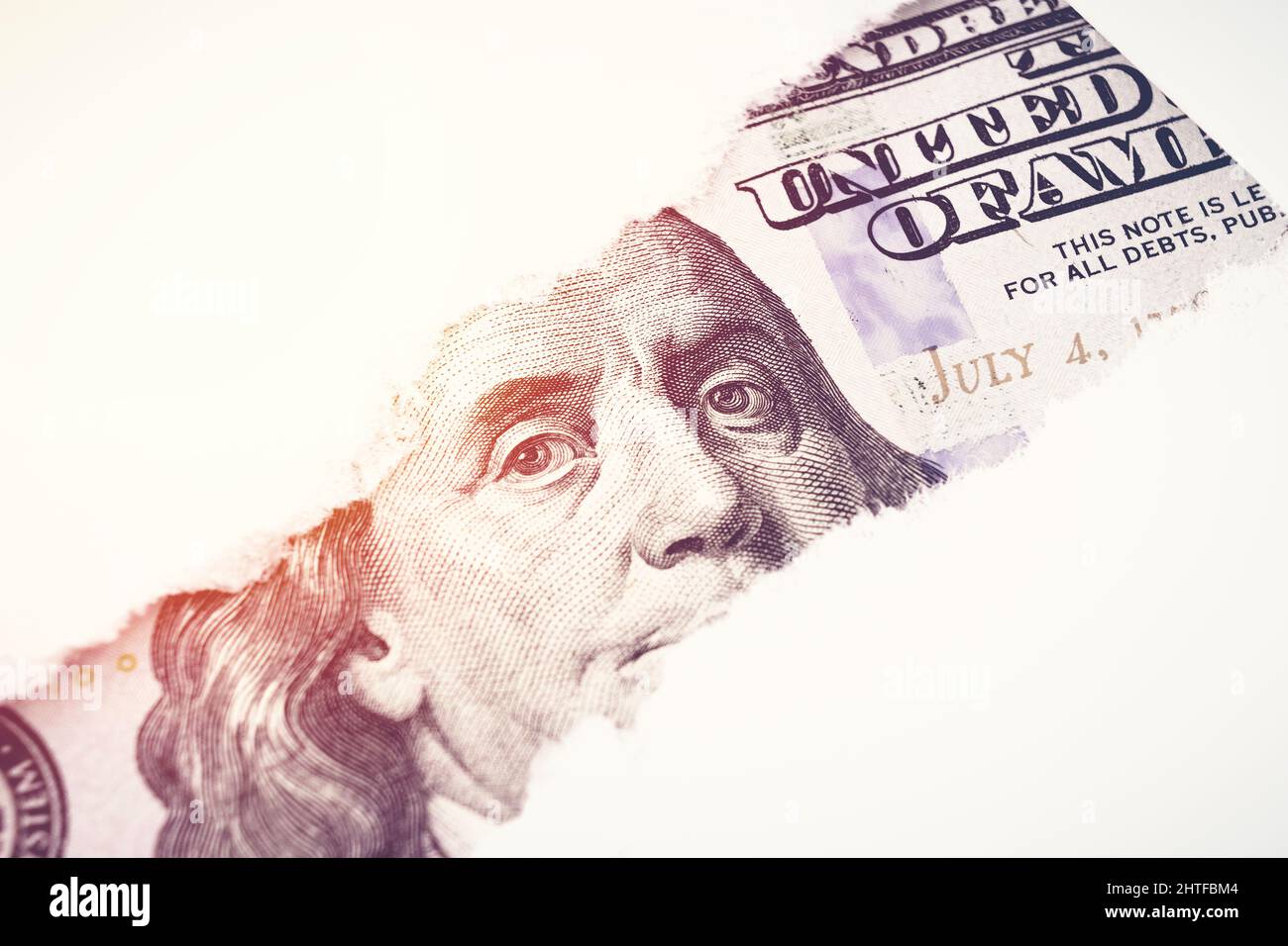 Benjamin Franklin in torn paper hole. Hundred dollar bill close-up fragment. Hundred dollars bill fragment on macro Stock Photo