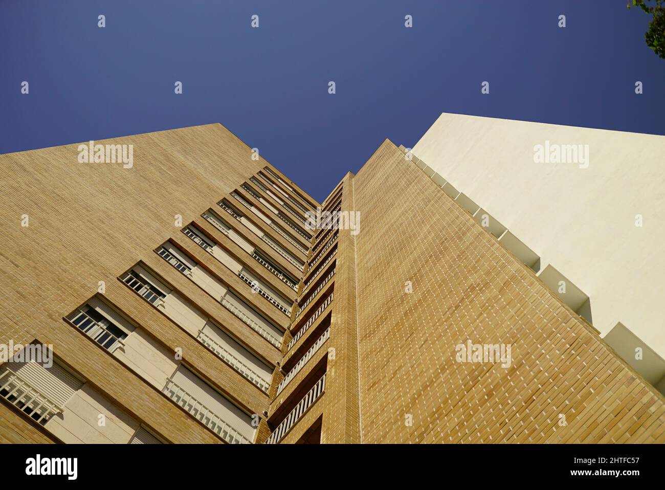 Low angle shot of a modern residential building under a blue sky Stock ...