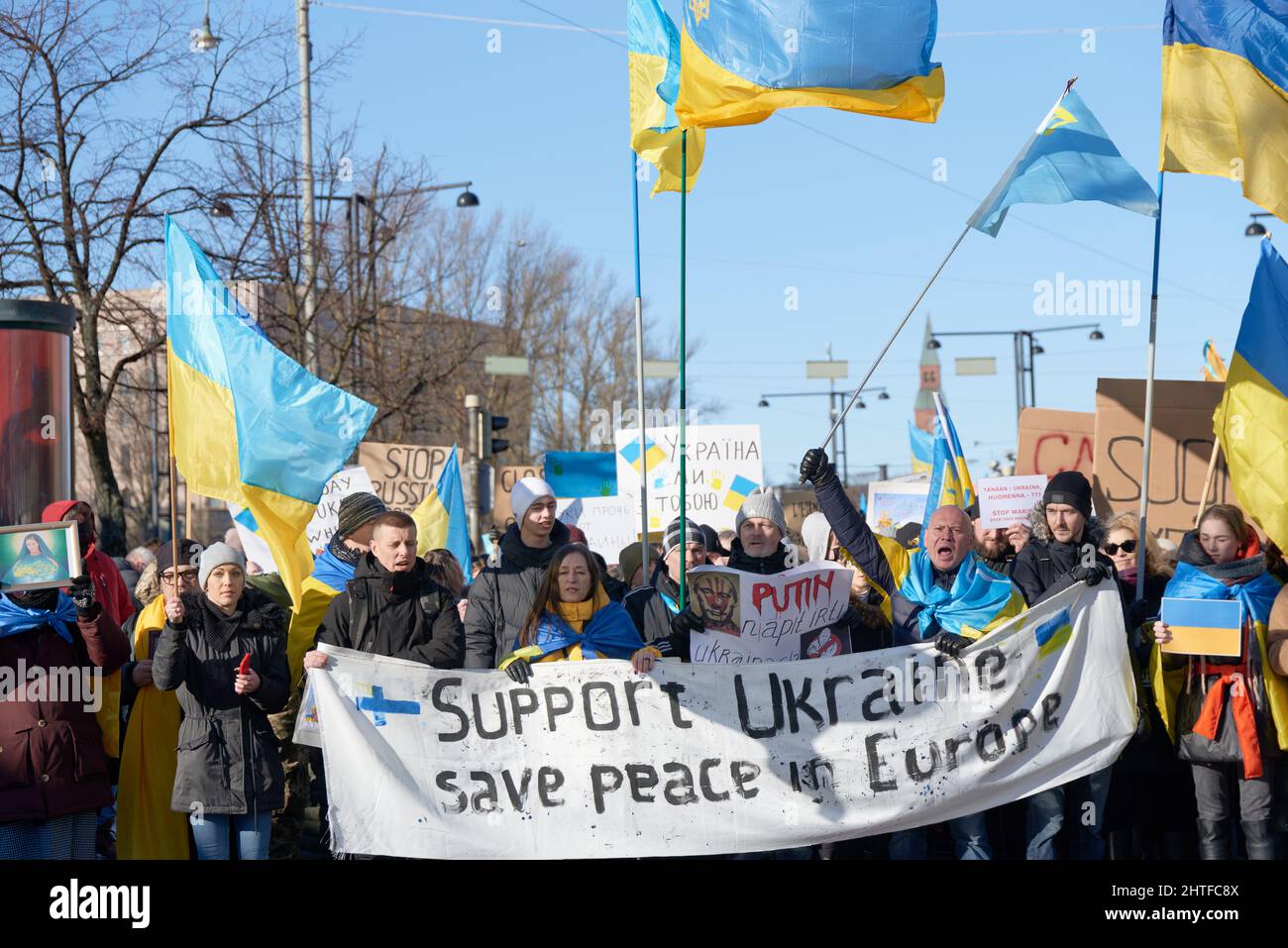 Helsinki, Finland - February 26, 2022: Demonstrators in a rally against Russia’s military actions and occupation in Ukraine march in Mannerheimintie i Stock Photo