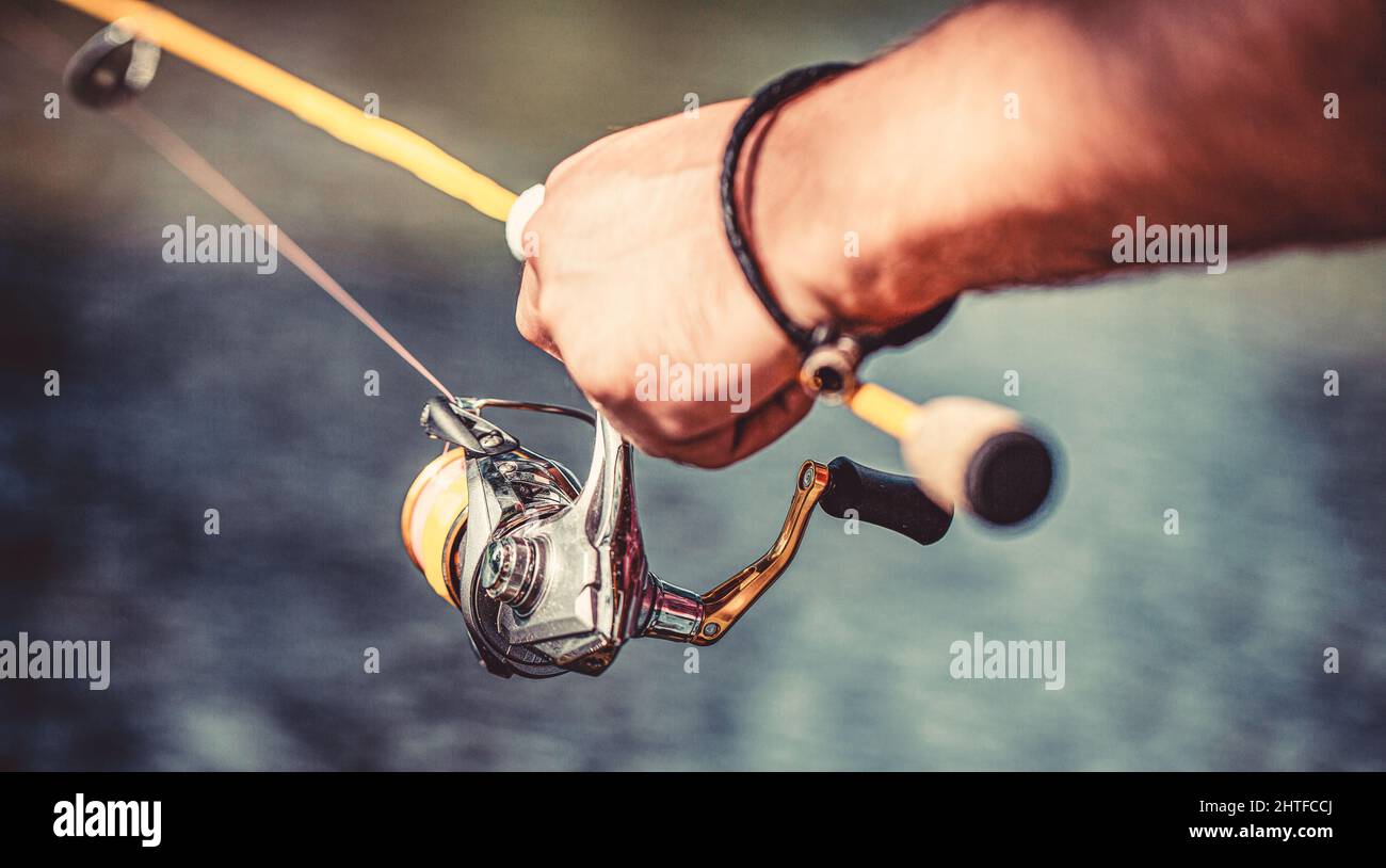 Fisherman hand holding fishing rod with reel. Fishing Reel. Fishing Rod  with Aluminum Body Spool. Fishing Gear. Fish Supplies and Equipment. Fishing  Stock Photo - Alamy