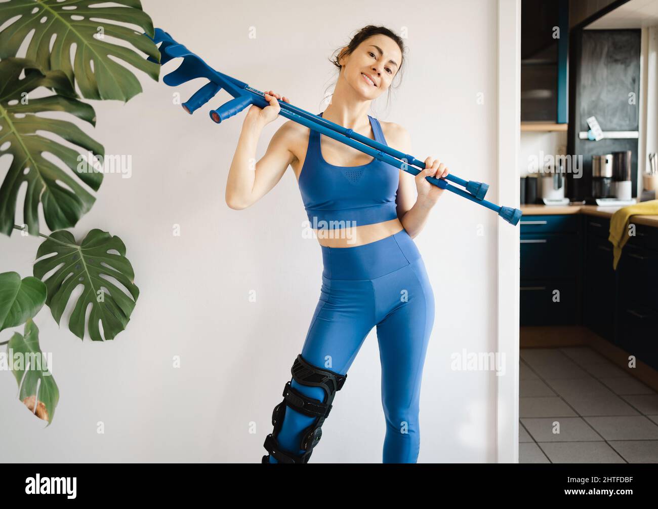 Knee injury young woman with crutches Stock Photo Alamy