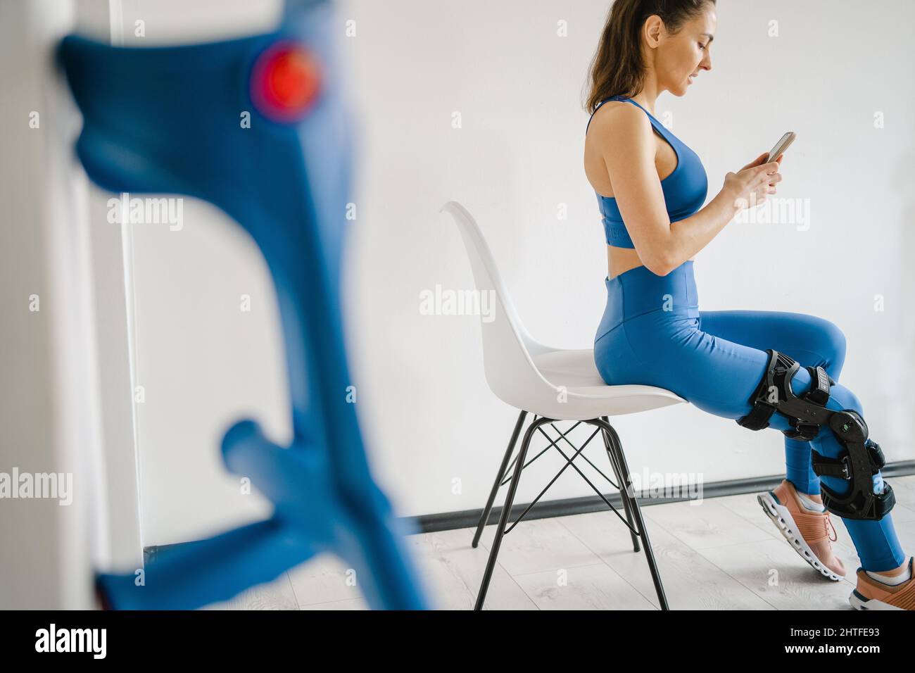 Knee injury young woman with crutches  Stock Photo