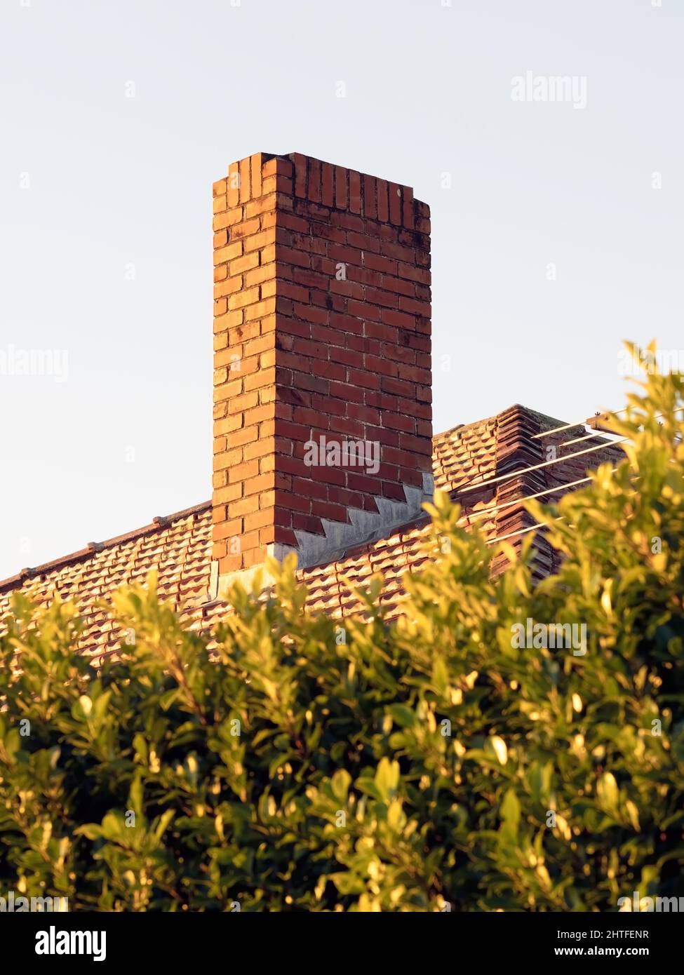 red tile house roof with red brick chimney Stock Photo - Alamy