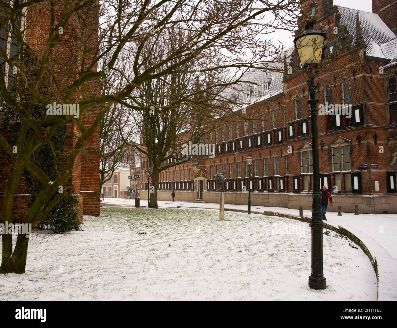 Window with shutters on an ancient building of the province of Groningen with some snow in the winter Stock Photo