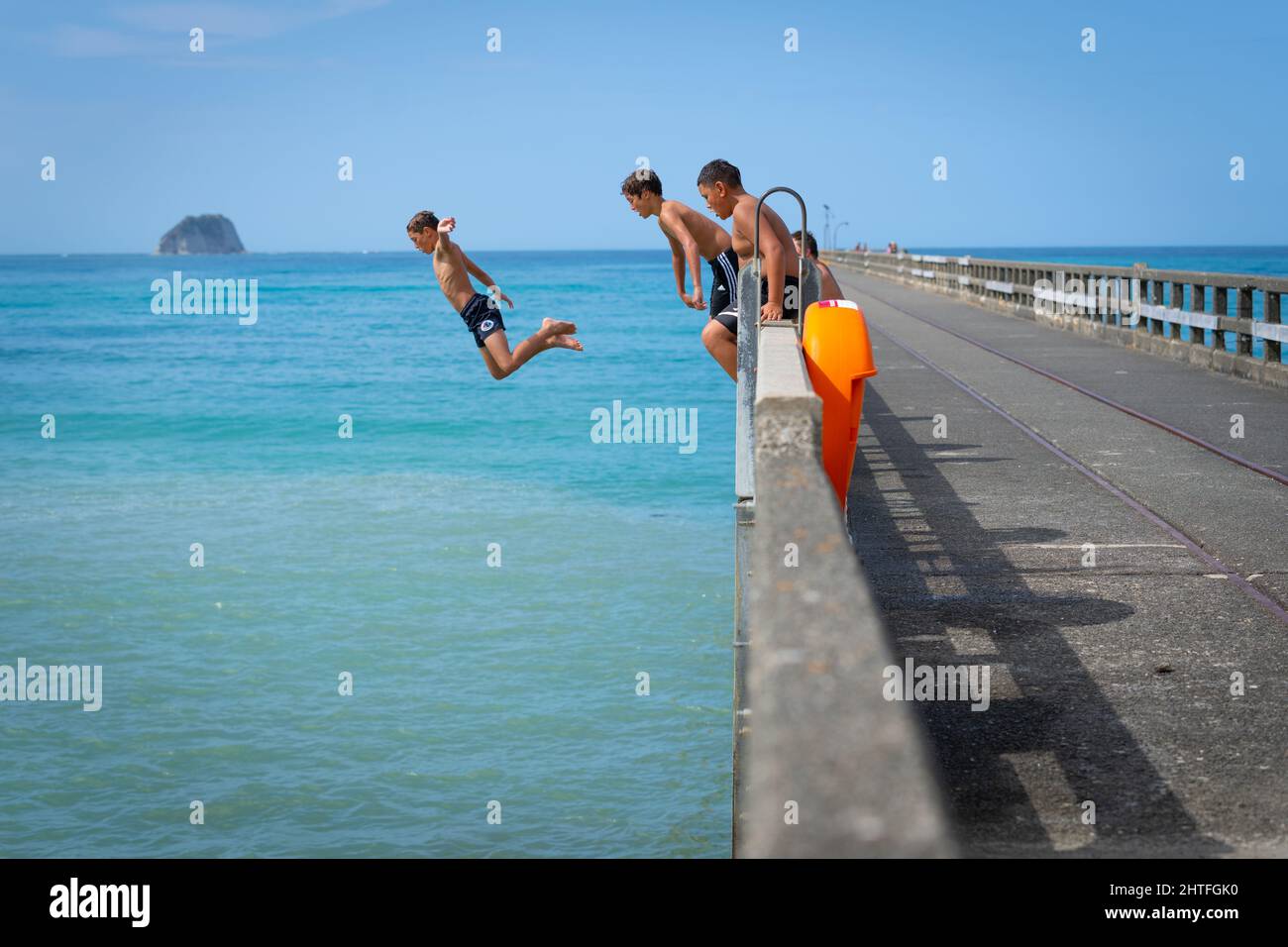 Tolaga Bay New Zealand February 5 2022; Local boys jumping of Tolaga