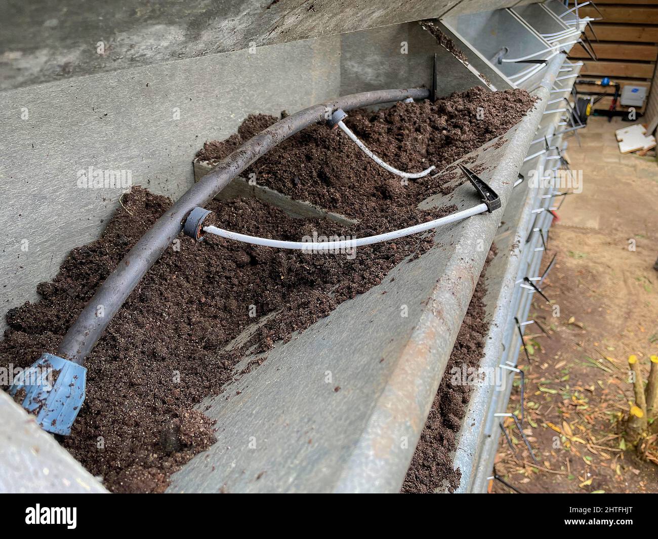 Irrigation system for watering a vertical green wall garden on behalf