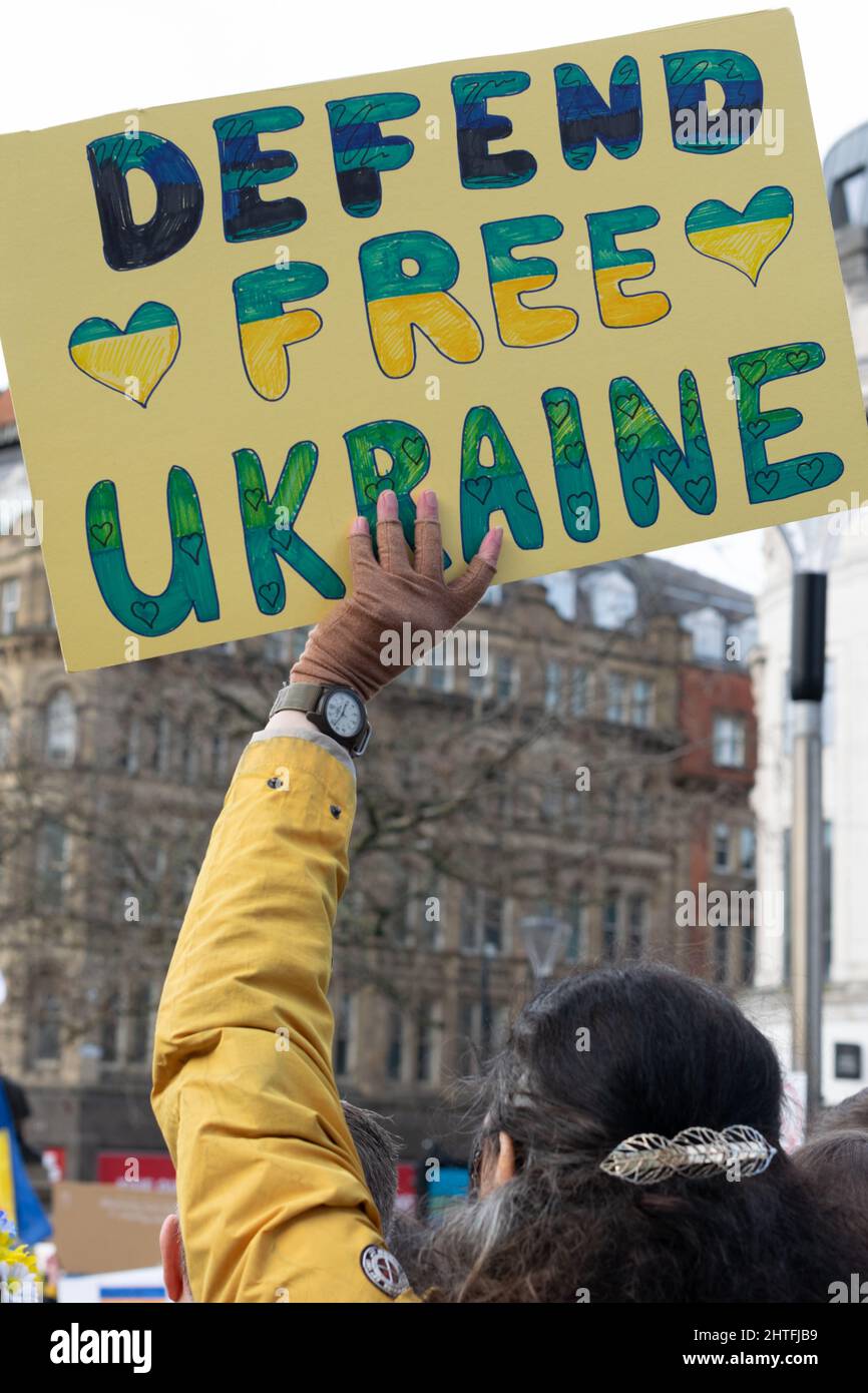 Stand With Ukraine protest, Piccadilly Gardens, Manchester. Protester with sign text Defend Free Ukraine Stock Photo