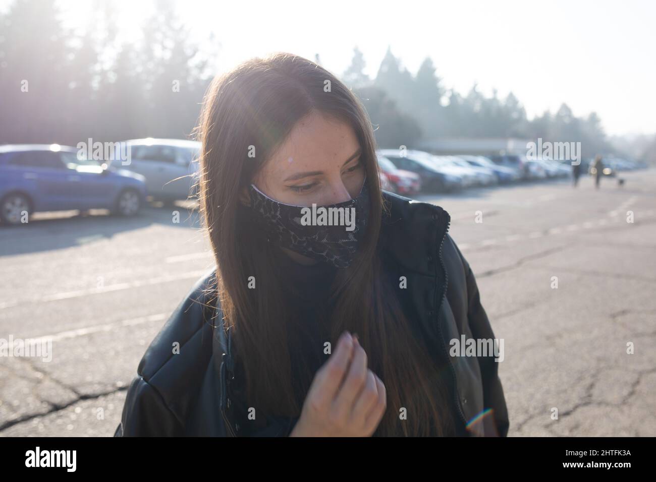 girl wearing mask outside on parking during pandemic covid-19 Stock Photo