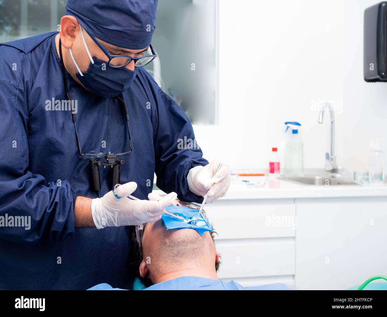 Dentist fixing chipped or broken teeth of the patient in the dental