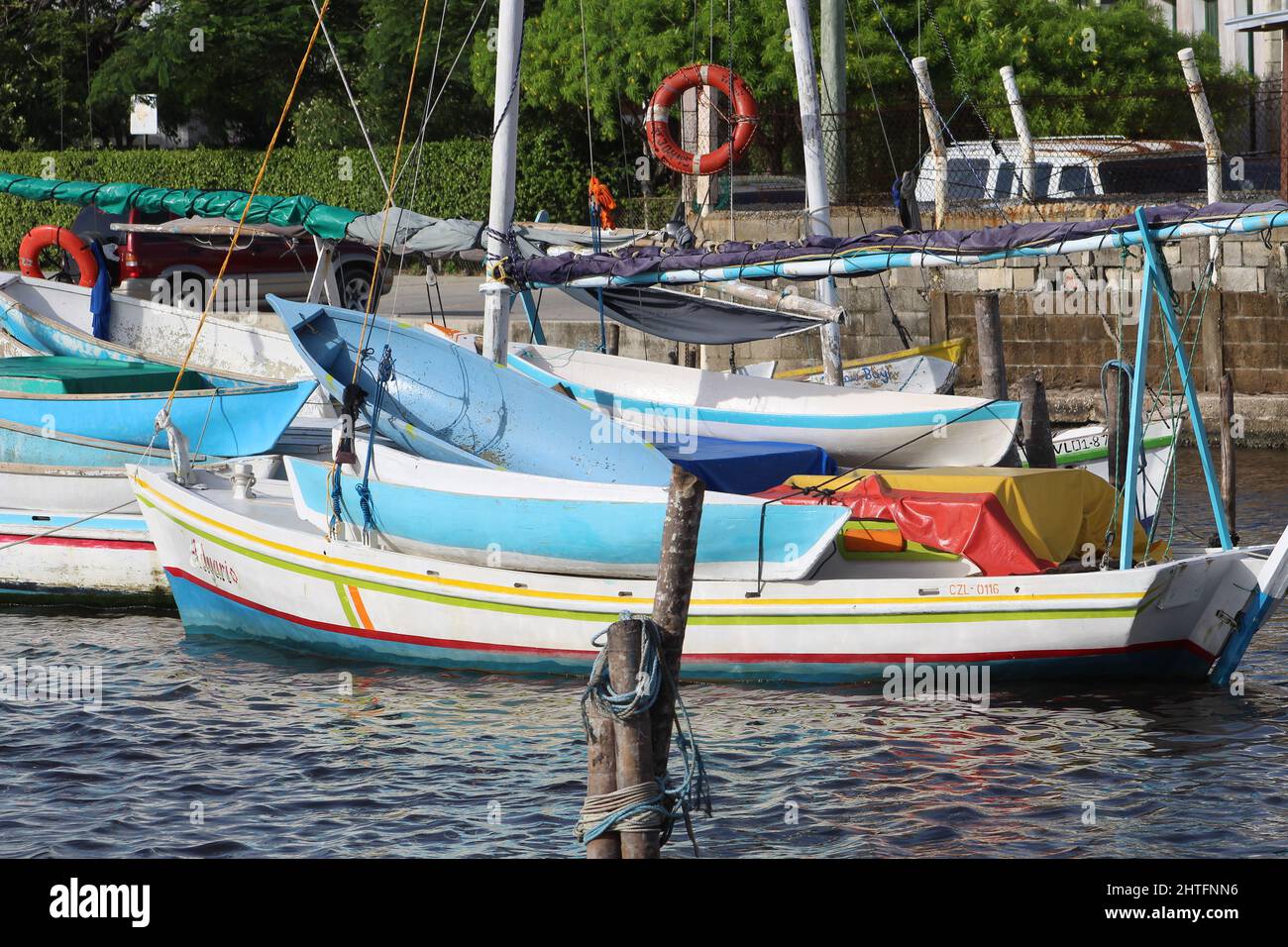 BELIZE CITY, BELIZE - JULY 6, 2016 multicoloured fishing boats moored at the Swing Bridge with fishermen and boats from Sarteneja Stock Photo