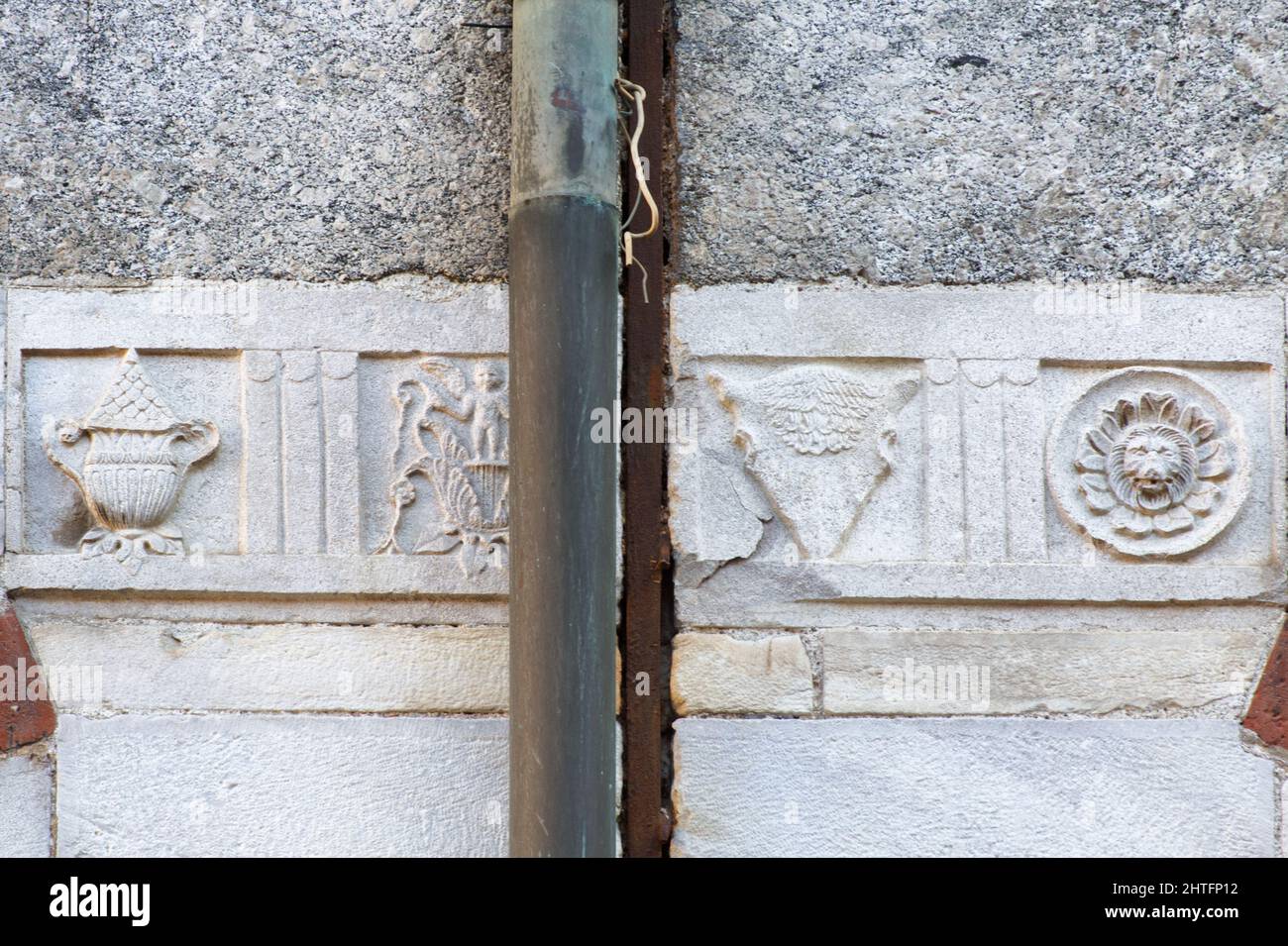 Relief with symbols - Palazzo della Ragione, Milan Stock Photo