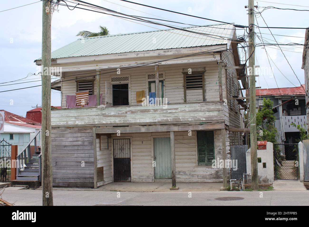 BELIZE CITY, BELIZE - SEPTEMBER 24, 2016 traditional wooden houses with green louvered windows in downtown Belize City Stock Photo