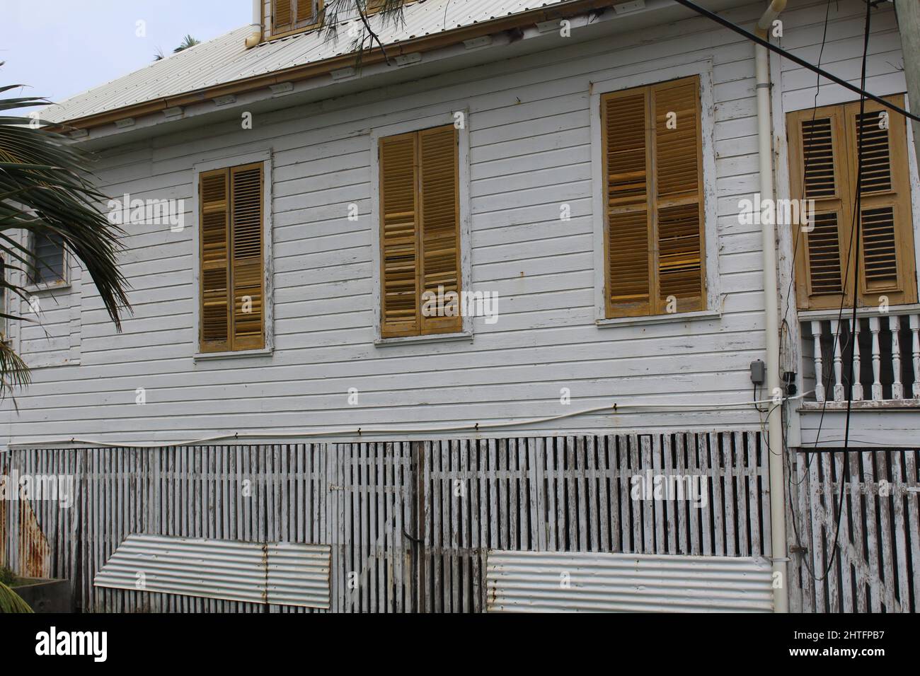 BELIZE CITY, BELIZE - SEPTEMBER 24, 2016 traditional wooden houses with yellow louvered windows in downtown Belize City Stock Photo
