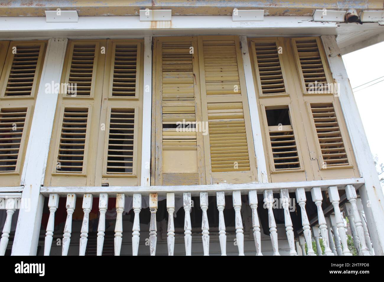 BELIZE CITY, BELIZE - SEPTEMBER 24, 2016 traditional wooden houses with yellow painted louvered windows in downtown Belize City Stock Photo