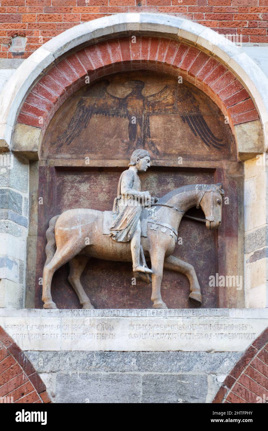 The relief representing Oldrado, a fierce prosecutor and butcher of the Cathar heretics - Palazzo della Ragione, Milan Stock Photo