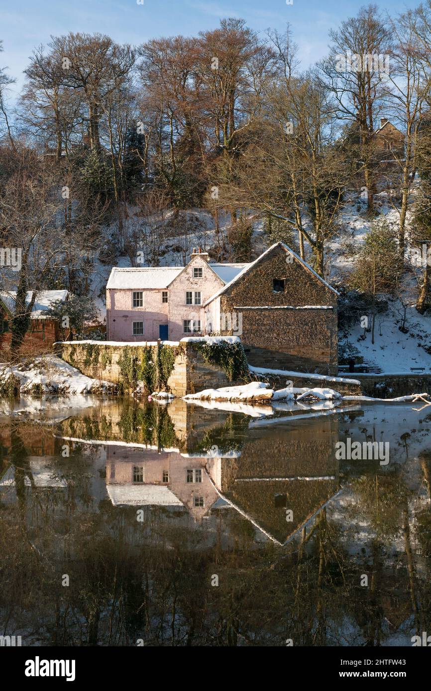 Winter view of the old corn mill reflected in the river Wear in Durham city, England, UK December 2010 Stock Photo