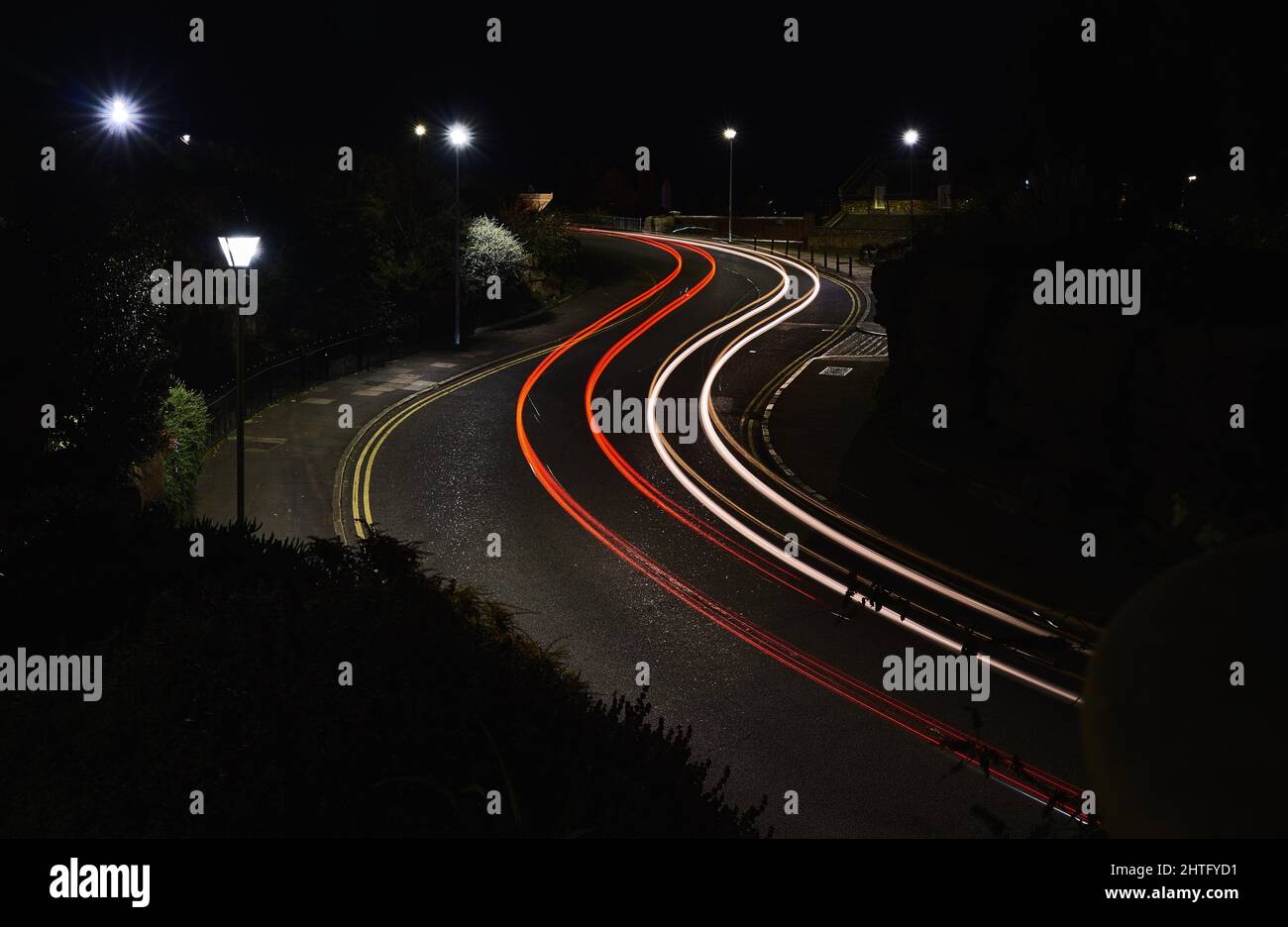 Red and white light trails on an s bend Stock Photo