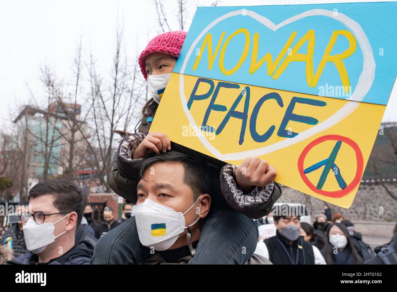 Seoul, South Korea. 28th Feb, 2022. A child holds a placard saying 'No War and Peace' during a protest against Russia's attack in Ukraine outside of Russian embassy in Seoul. Credit: SOPA Images Limited/Alamy Live News Stock Photo