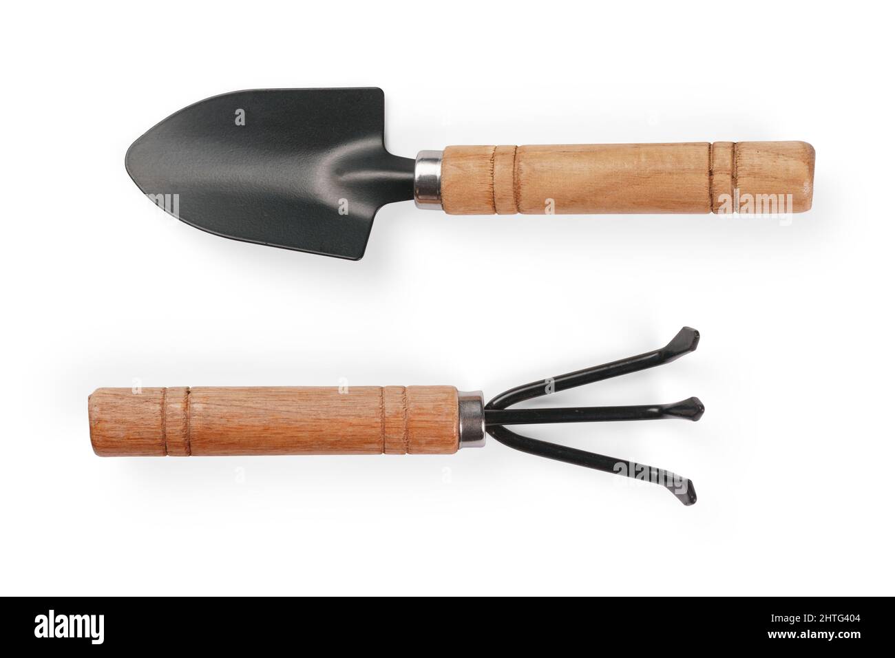 Small shovel and rake with wooden handle. Isolated on white, clipping path included Stock Photo