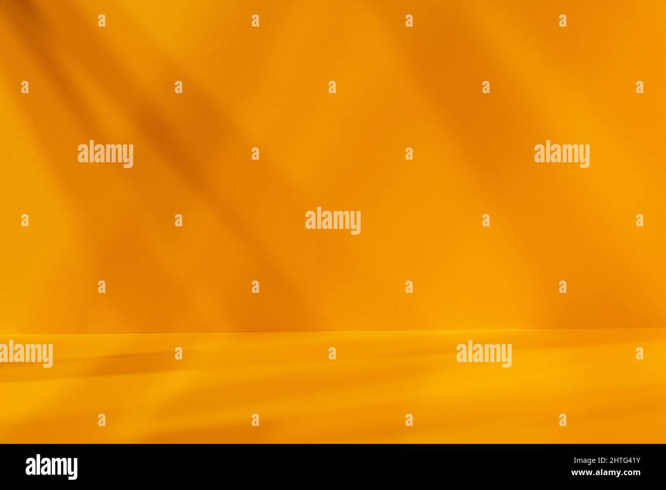 Empty yellow studio space with deep artistic shadow. Minimalistic space concept Stock Photo