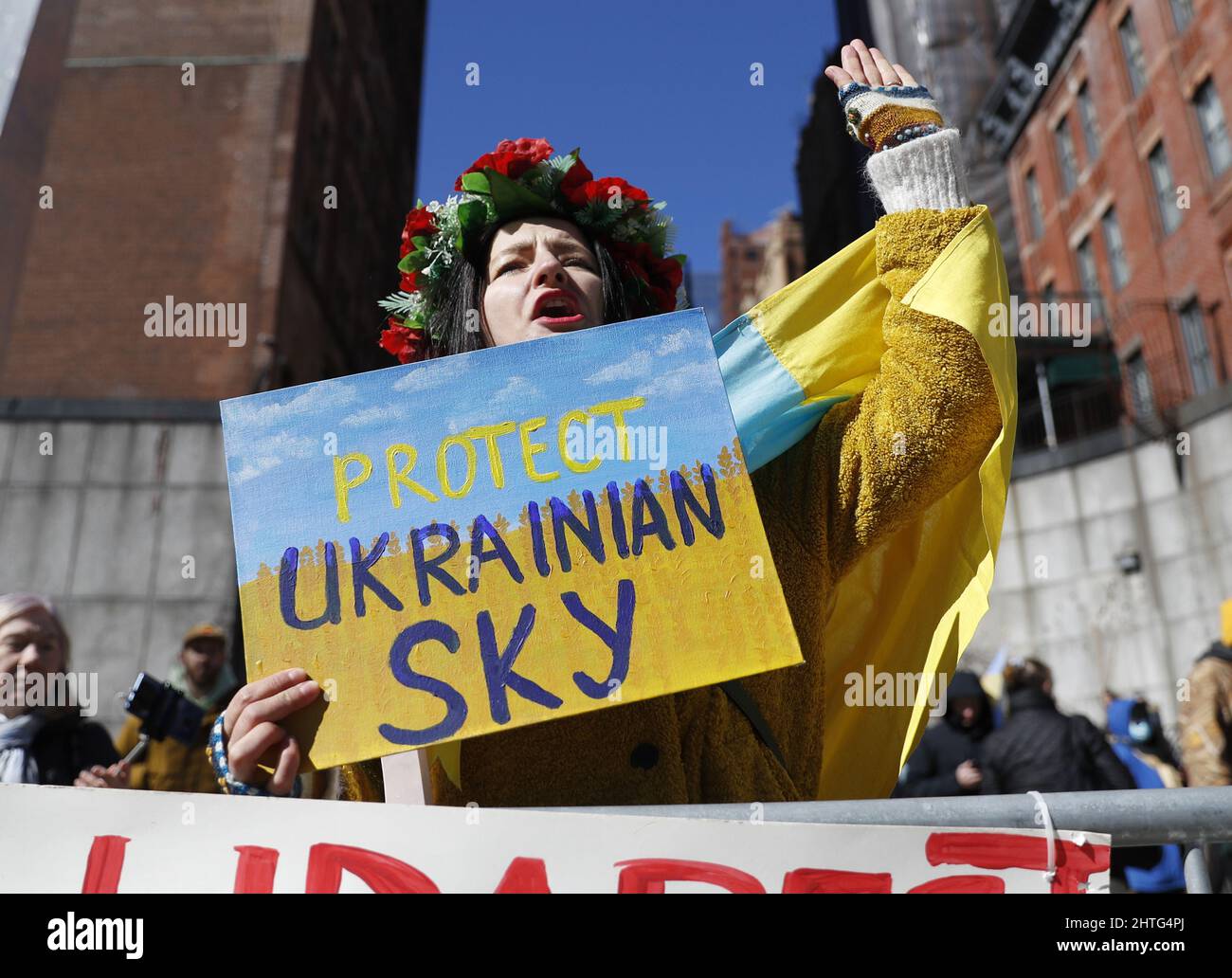 New York, United States. 28th Feb, 2022. A protester wears the flag of Ukraine outside of the United Nations at a rally while the Eleventh Emergency Special Session on the Ukraine Russia conflict takes place in General Assembly Hall at United Nations Headquarters in New York City on Monday, February 28, 2022. A Ukrainian delegation has arrived near the border with Belarus to hold talks with Russian officials.Ukraine's armed forces continue to hold off Russian troops while defending key cities and slowing Russia's advance on Kyiv. Photo by John Angelillo/UPI Credit: UPI/Alamy Live News Stock Photo