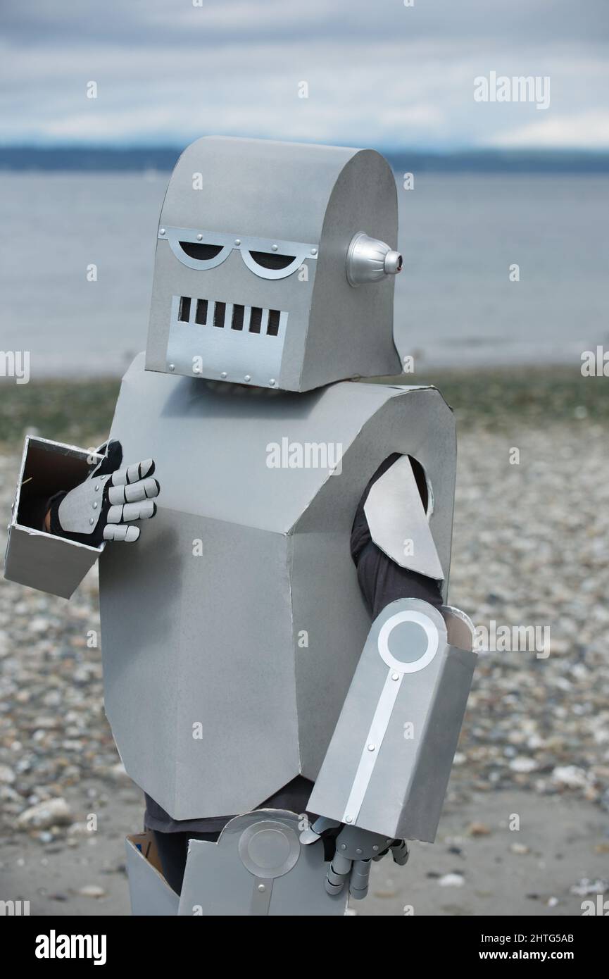 Home made robot being expressive while standing on the beach. Gesturing robot. Emotional robot talking. Robo-advisor. Stock Photo
