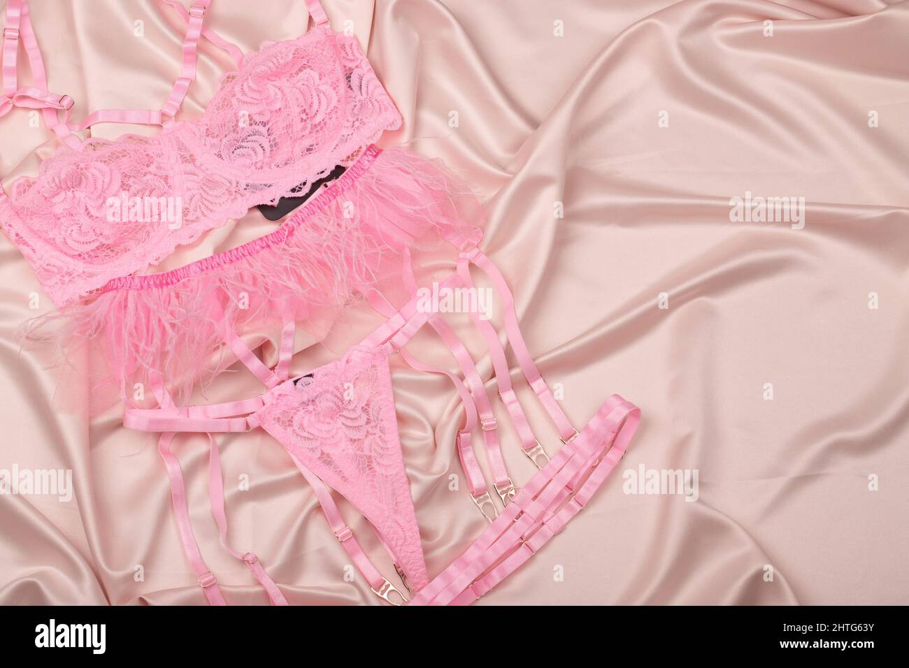 Glamorous stylish sexy lace lingerie on a satin background. Women's bra, panties, erotic clothes. Gift, shopping and fashion concept.Copy space. Stock Photo