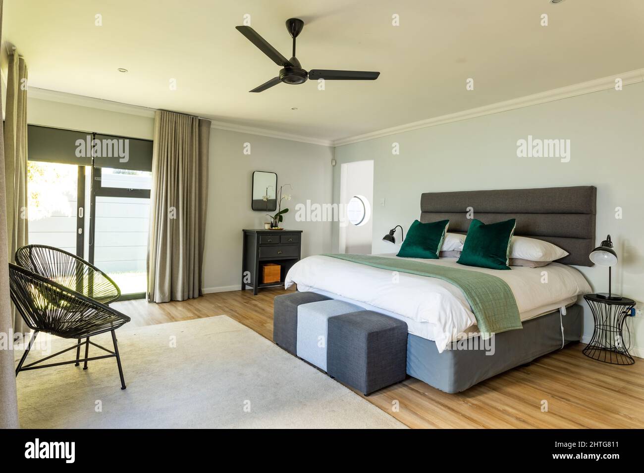 Chairs and bed with furniture in bedroom at home Stock Photo Alamy