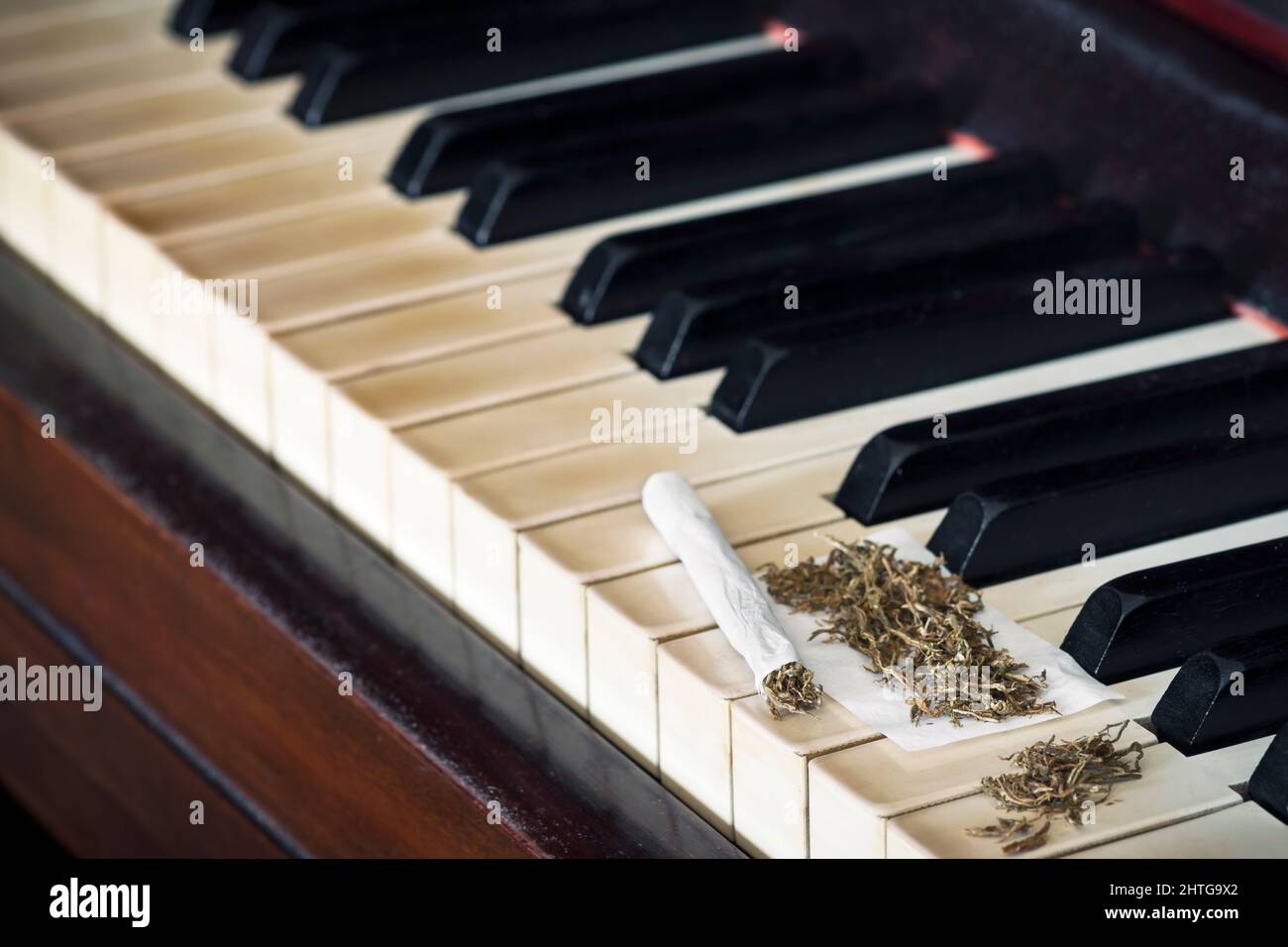 Selective focus of a rolling cigarette on a piano Stock Photo