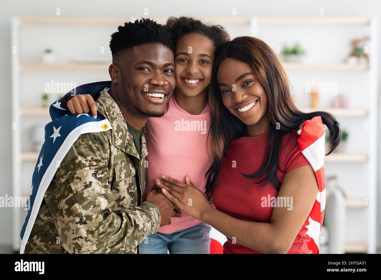 Beautiful black family posing with flag of the US Stock Photo