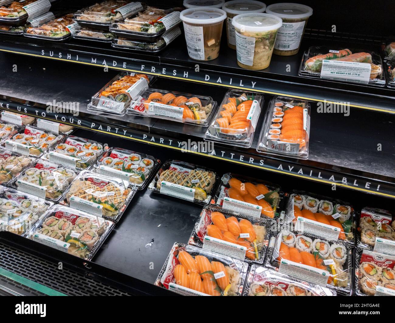 Kirkland, WA USA - circa February 2022: Angled view of prepackaged sushi varies inside a Whole Foods Market's prepared food section. Stock Photo