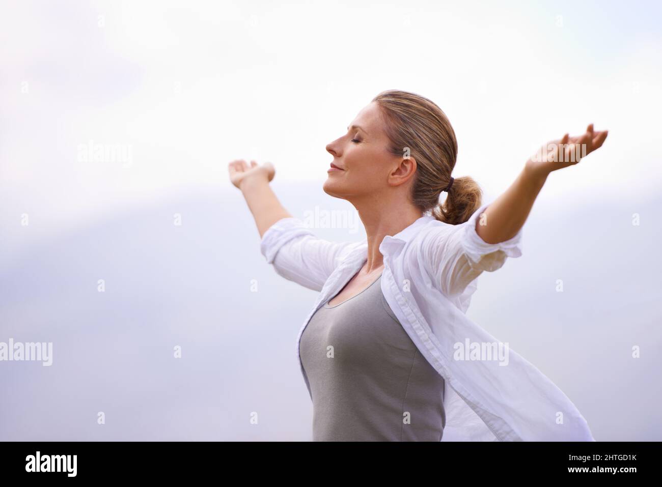 Feeling calm in nature. A woman doing yoga out. Stock Photo