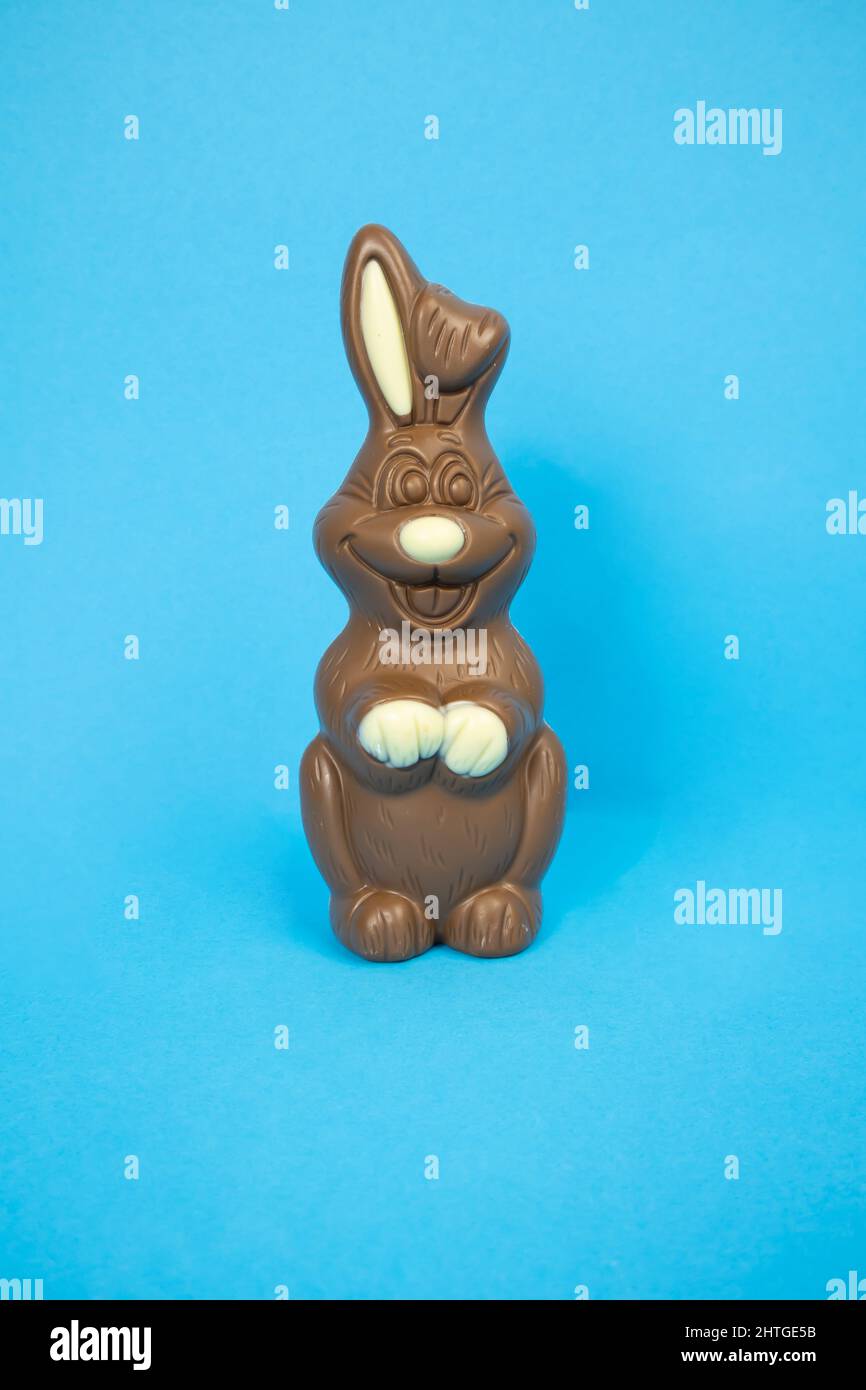 Easter chocolate bunny on a blue background vertically Stock Photo Alamy