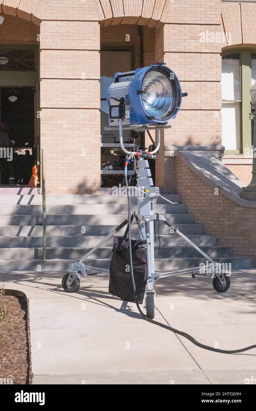 Georgetown, Texas  USA - Large spotlight on wheeled tripod support used to light outdoor movie scene on movie set Stock Photo