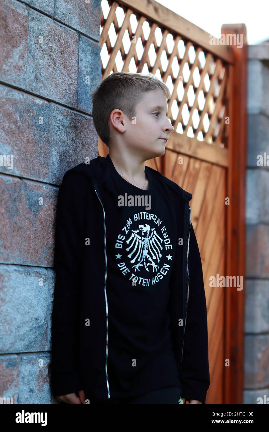 Child poses for a portrait with the t-shirt of the band "Die Toten Hosen"  in the garden Stock Photo - Alamy