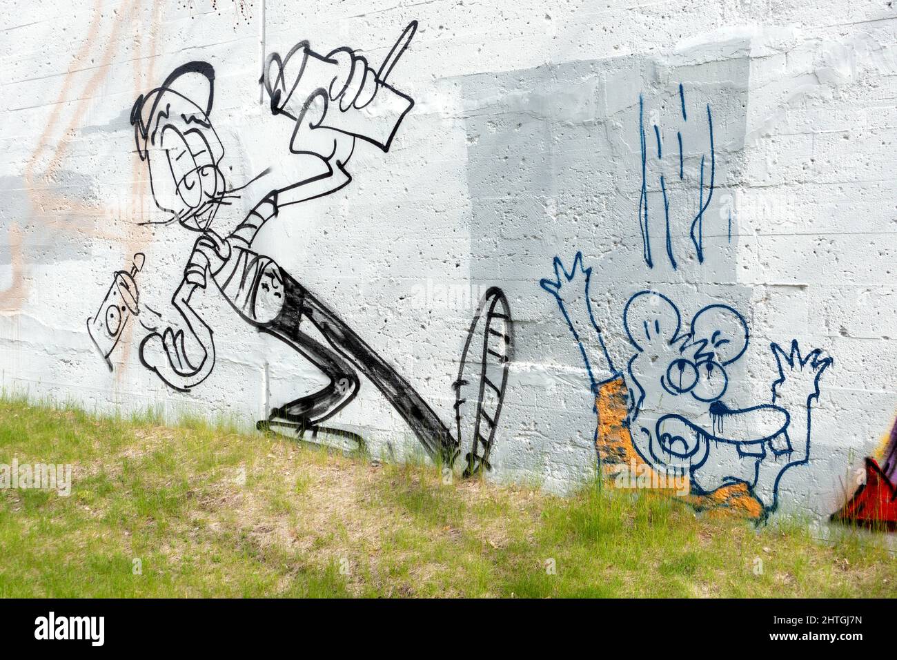 Humorous cartoon graffiti characters on a wall next to The Midtown Greenway bicycle trail. Minneapolis Minnesota MN USA Stock Photo