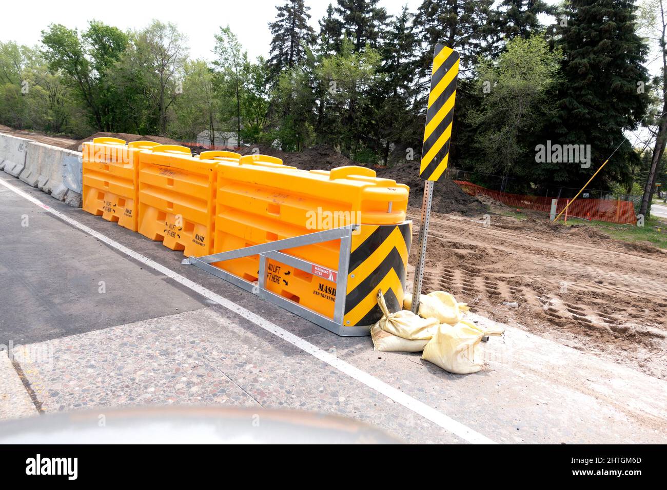 Highway yellow buffer cushions for separating cars from the concrete barriers during road construction. Nisswa Minnesota MN USA Stock Photo