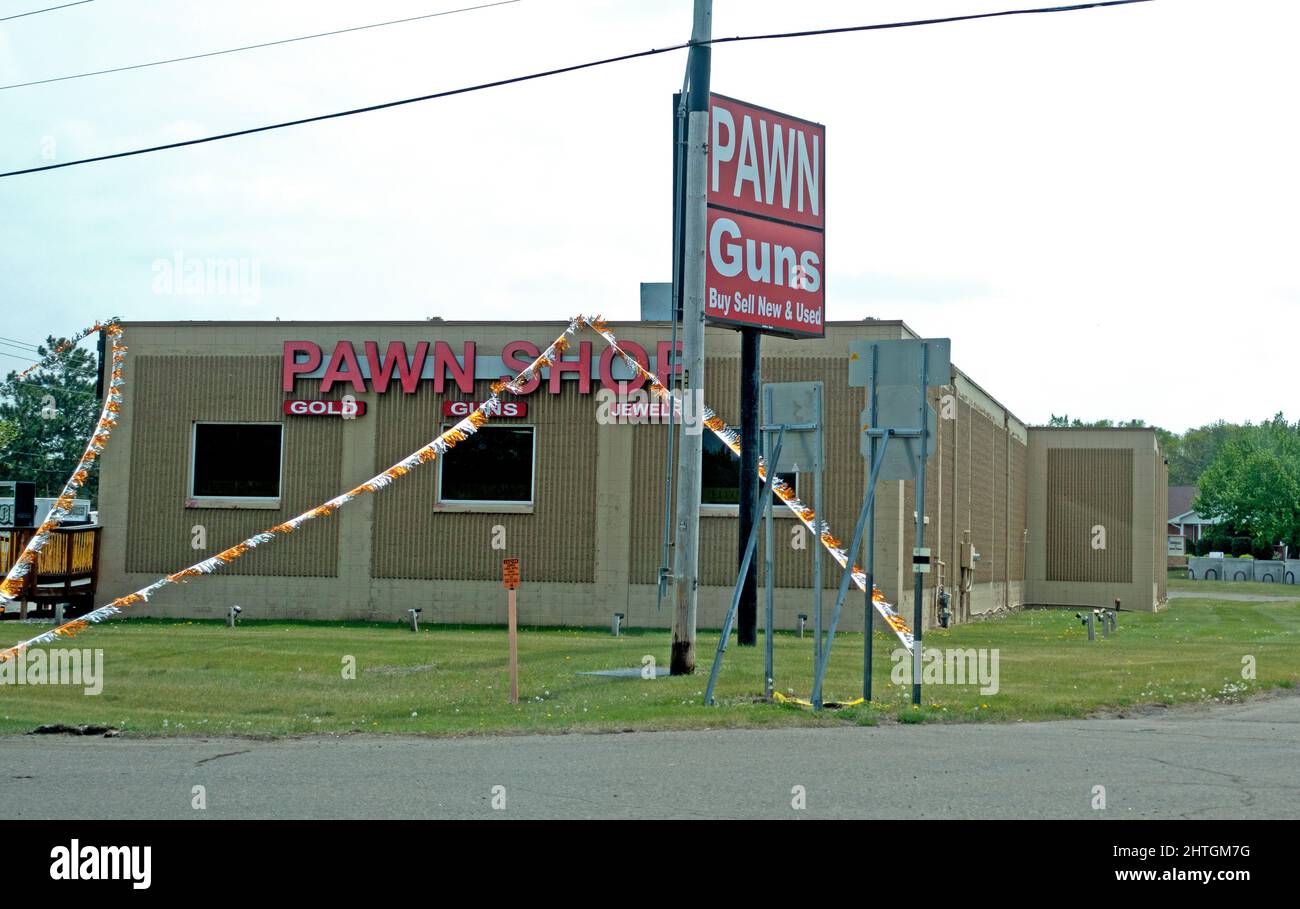 Pawn Shop specializing in buying and selling guns along with gold and jewelry both new and used. Anoka Minnesota MN USA Stock Photo