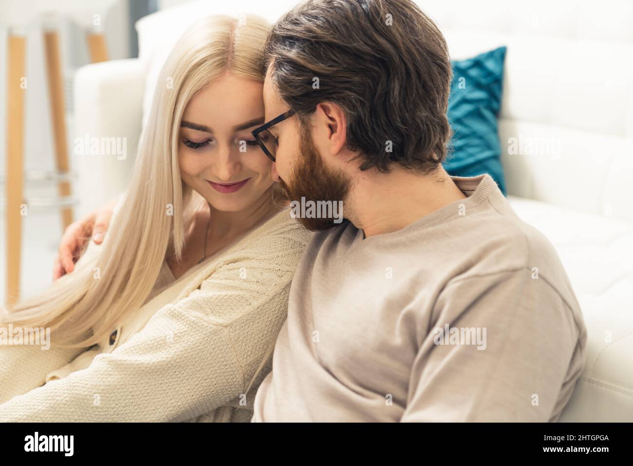 beautiful intimate bond between long-haired blonde woman and her bearded spouse . High quality photo Stock Photo