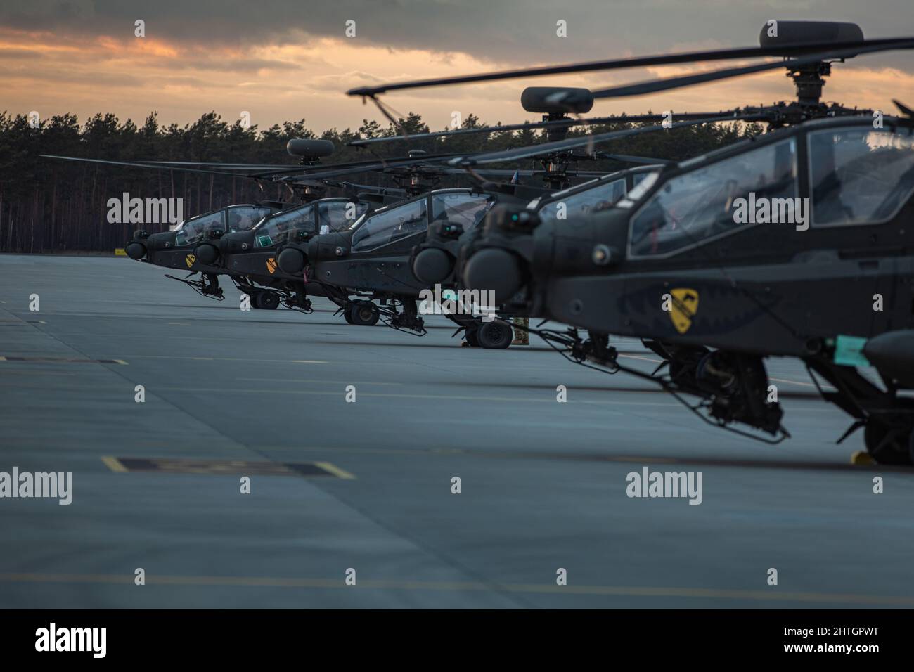 Lask, Poland. 25 February, 2022. U.S. Army AH64 Apache attack helicopters with the 7th Squadron, 17th Cavalry Regiment of the 1st Air Cavalry Brigade on the ramp at Lask Air Base, February 25, 2022 in Lask, Poland. The U.S. has increased NATO forces in the region to counter the Russia threat against Ukraine.  Credit: Sgt. Agustín Montanez/U.S Army/Alamy Live News Stock Photo