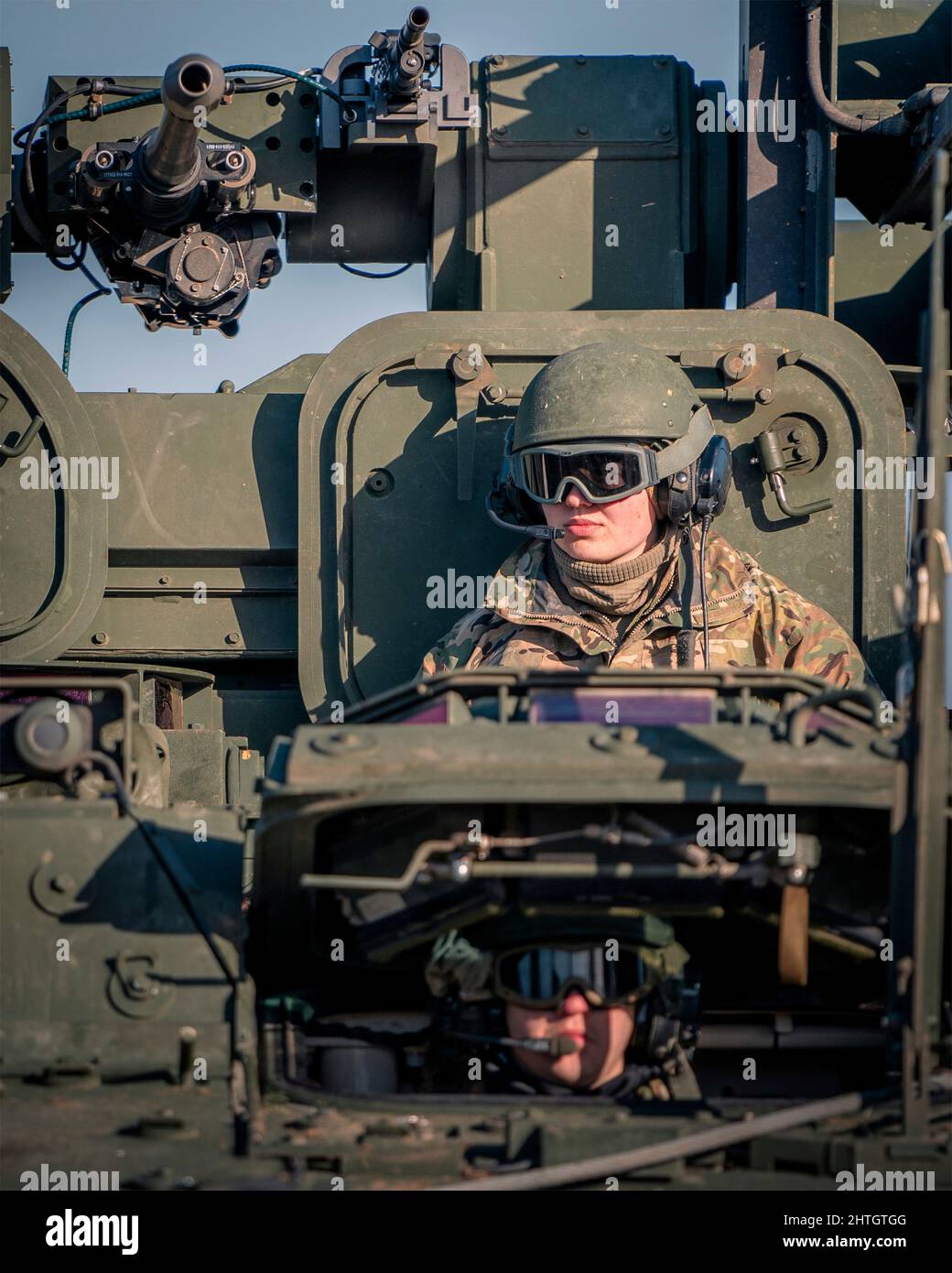 Orzysz, Poland. 24 February, 2022. U.S. Army soldiers, assigned to 5th Battalion, 4th Air Defense Artillery Regiment, direct a Stryker A1 IM-SHORAD system at Bemowo Piskie Training Area, February 24, 2022 outside of Orzysz, Poland. The U.S. has increased NATO forces in the region to counter the Russia threat against Ukraine.  Credit: Maj. Robert Fellingham/U.S Army/Alamy Live News Stock Photo