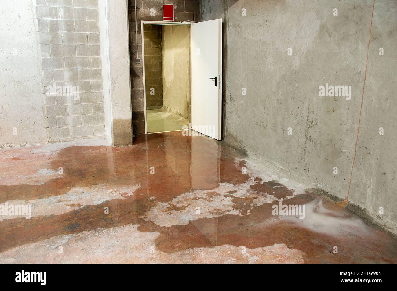 Water damage in basement caused by sewer backflow due to clogged sanitary drain Stock Photo