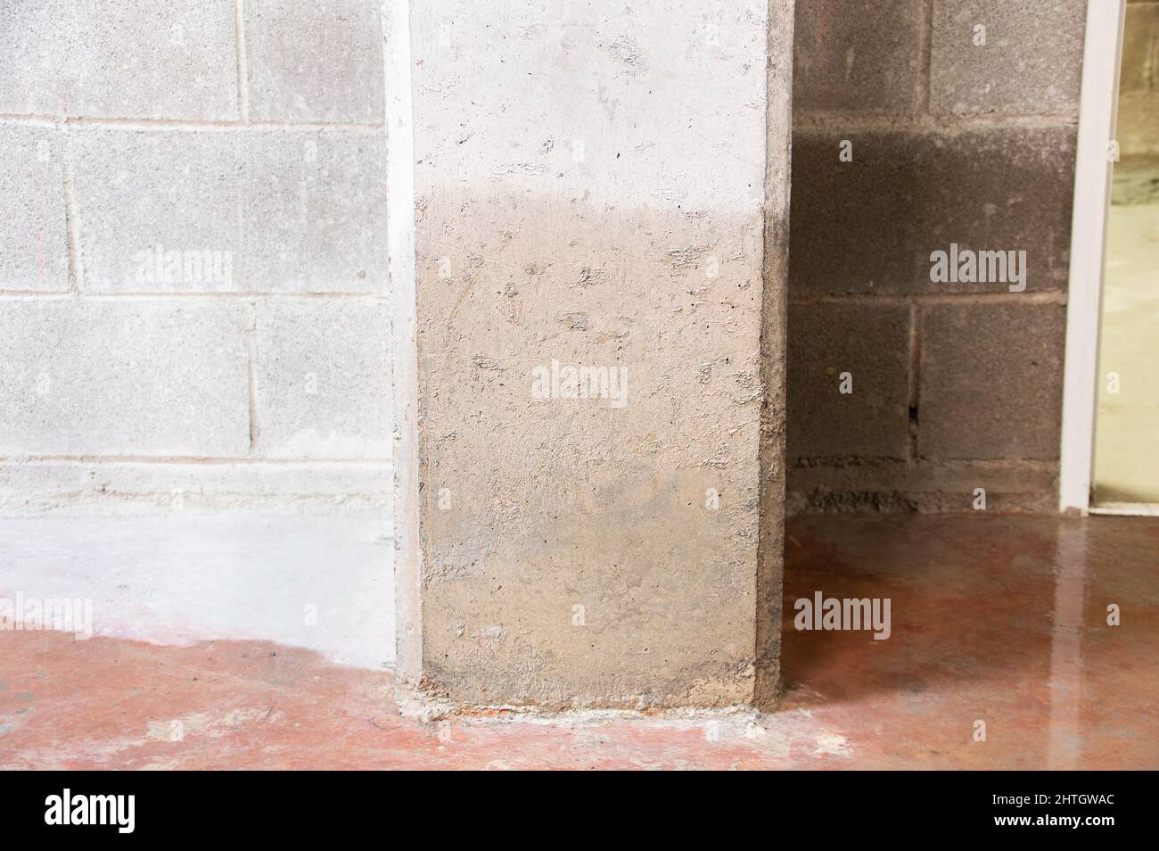 Damage to a concrete column from water in the basement Stock Photo