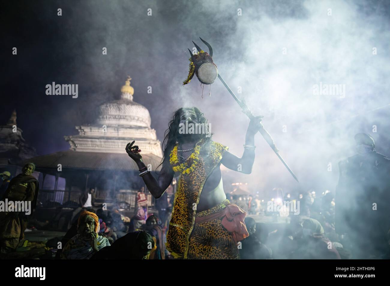 Kathmandu, Nepal. 28th Feb, 2022. A Hindu holy man or Sadhu, the follower of Lord Shiva performs Tandava a divine dance performed by Deity Shiva, a source of creation, dissolution and preservation on the eve of the Maha Shivaratri festival at the premises of Pashupatinath Temple. Credit: SOPA Images Limited/Alamy Live News Stock Photo