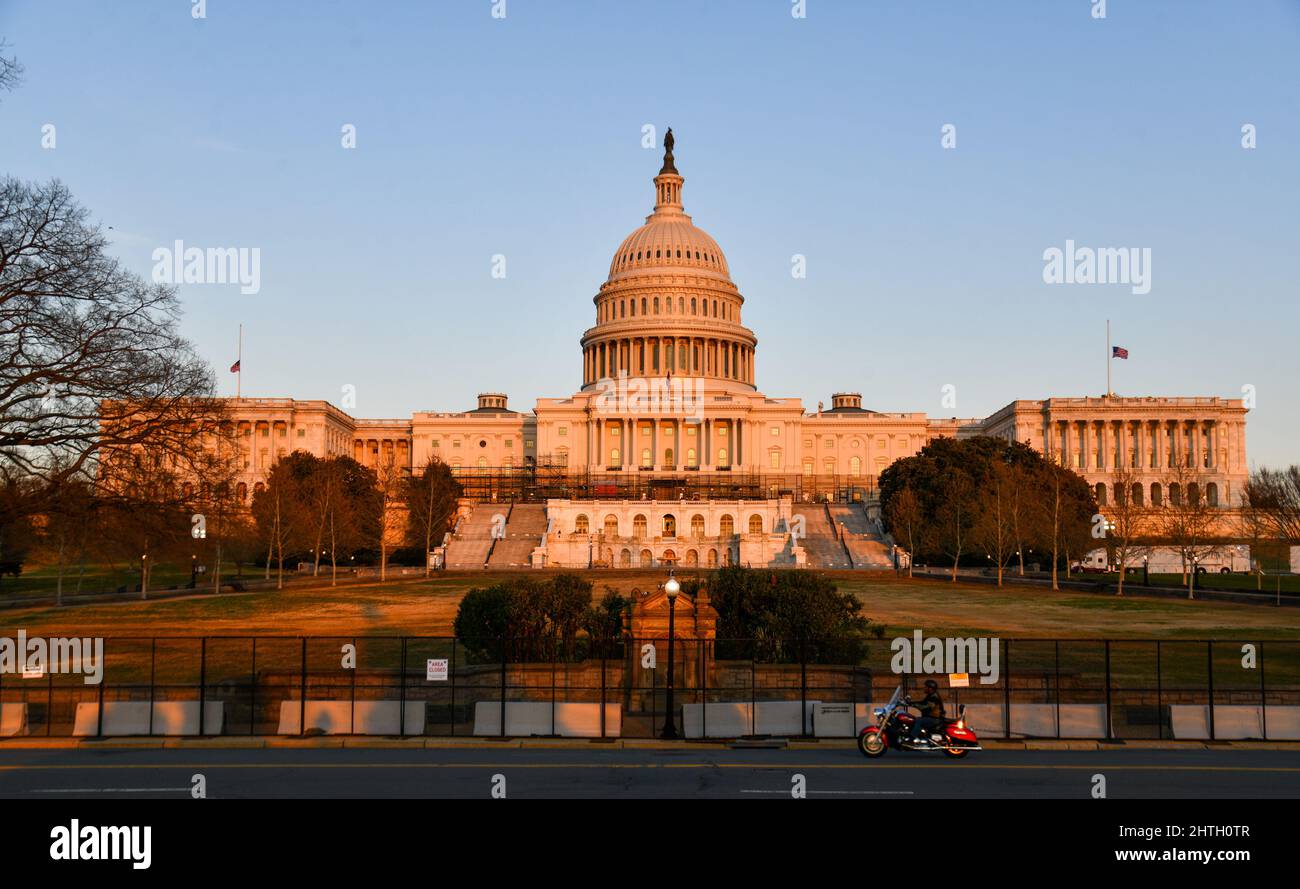 Washington, USA. 28th Feb, 2022. A motorcycle rides past security fencing reinstalled at the U.S. Capitol ahead of President Biden's State of the Union address in Washington, D.C on February 28, 2022. (Photo by Matthew Rodier/Sipa USA) Credit: Sipa USA/Alamy Live News Stock Photo