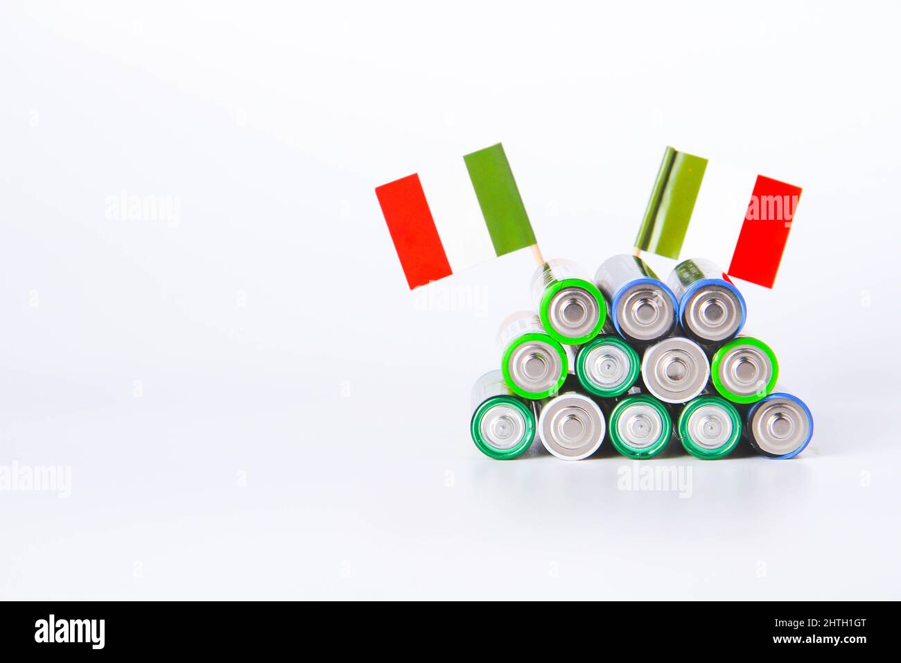 Battery. A lot of batteries on the background of the flag of italy