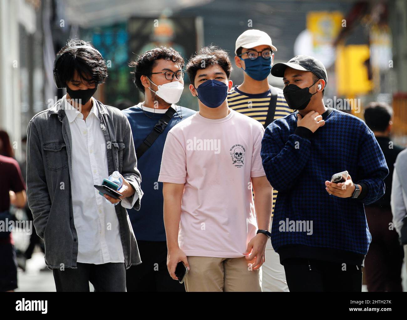 Kuala Lumpur, Malaysia. 28th Feb, 2022. Pedestrians wearing face masks