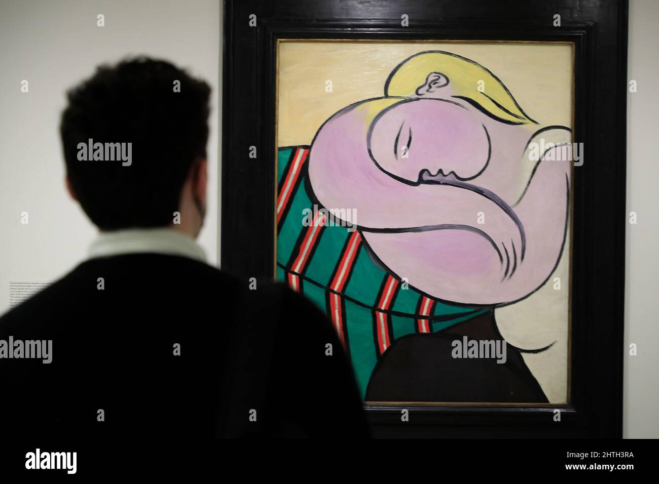 A visitor admiring Pablo Picasso's Woman with Yellow Hair in Guggenheim