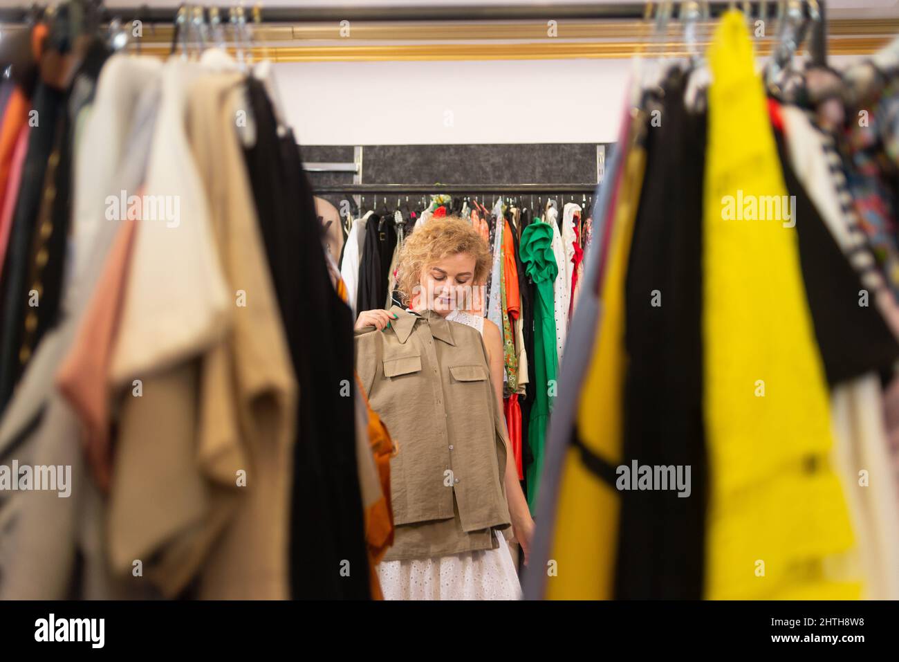 Shopping at the market or clothing store. Woman shopper trying on a