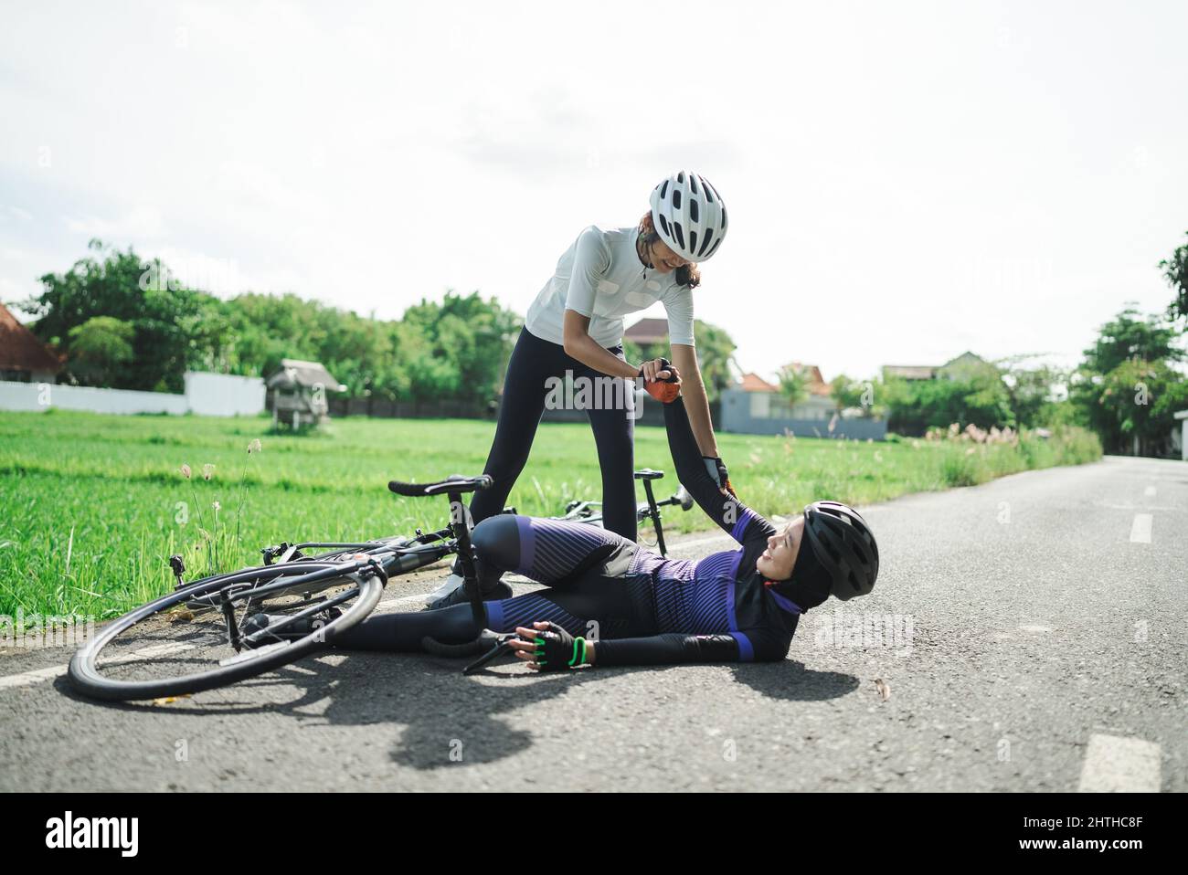 female cyclist having an accident on the road Stock Photo Alamy